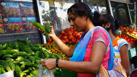 Woman buying vegetables at a market